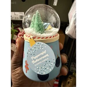The 2023 Huntington Home Snow Globe Candle in Peppermint Buttercream